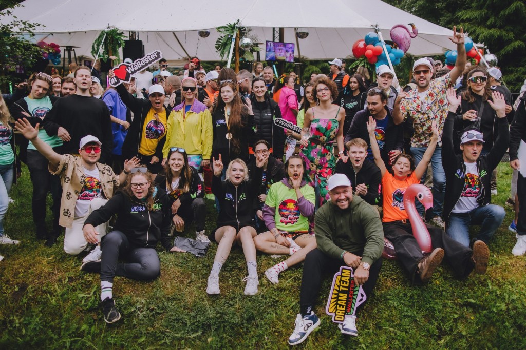 A diverse team collaborating in a modern office, representing a strong Employee Value Proposition at Wallester.